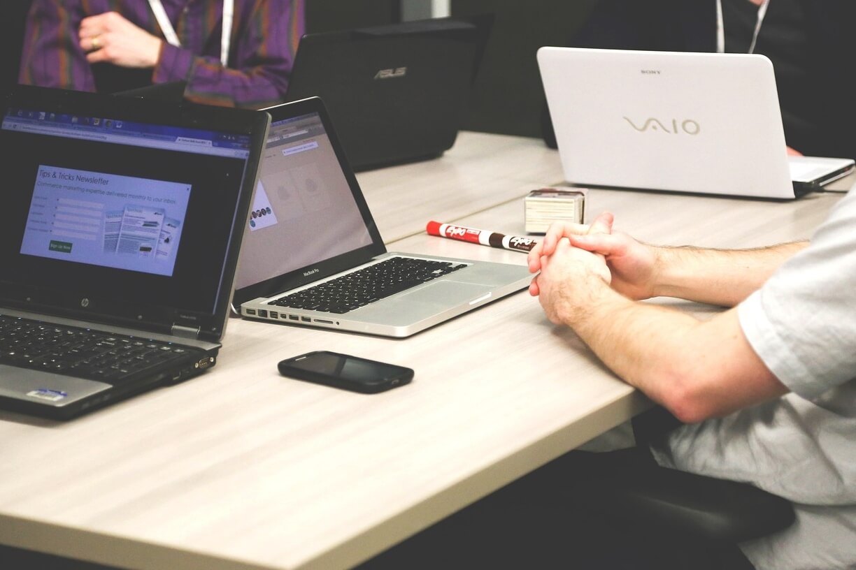 Development team collaborating with laptops during an agile sprint, building and shipping production code